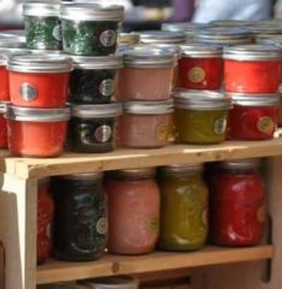Candle jars on a wooden shelf